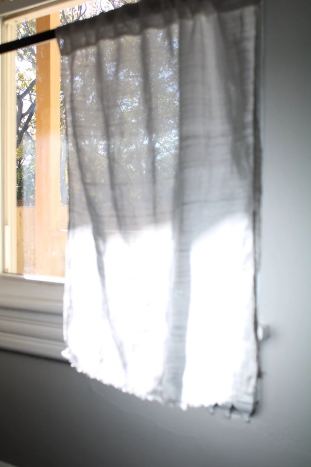 White curtains with natural sunlight in window.