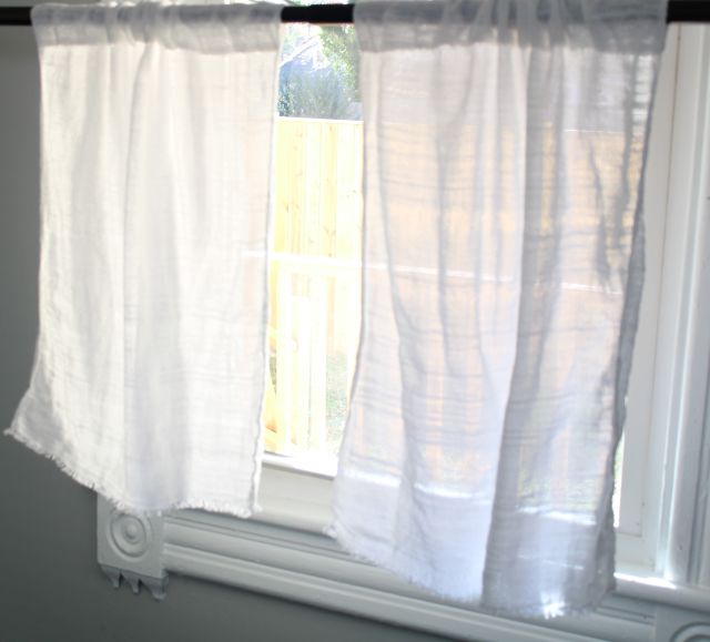 White handwoven bistro curtains in sunny window. Jacqueline's Textiles handwoven fabric in NOVA.