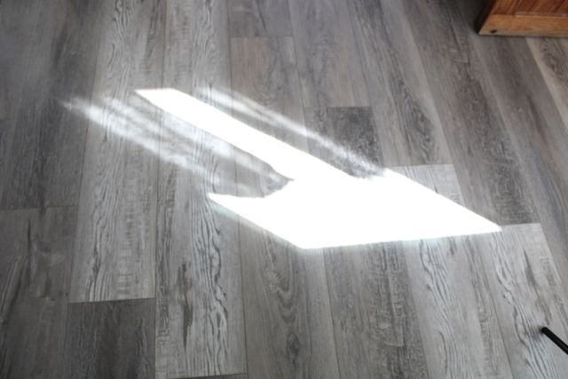 Shadow of handwoven curtains on floor. Jacqueline's Textiles handwoven fabric in NOVA.